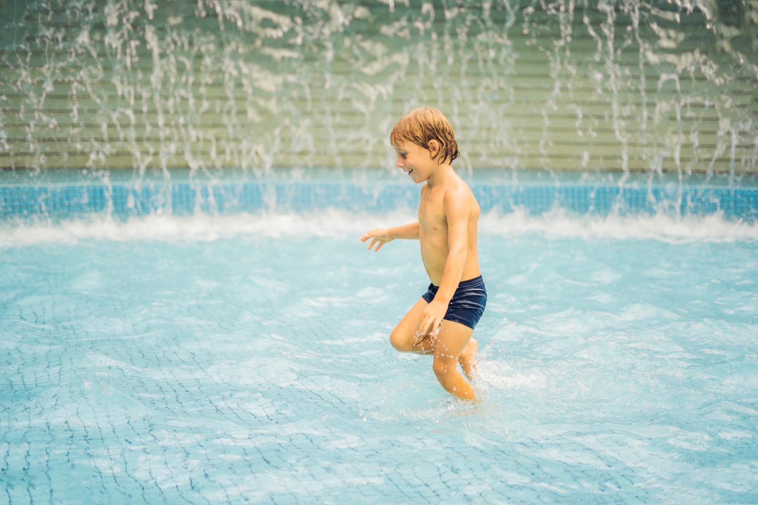 small-boy-having-fun-runing-in-swimming-pool.jpg